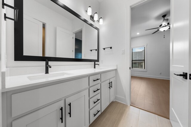 bathroom with vanity, hardwood / wood-style floors, and ceiling fan