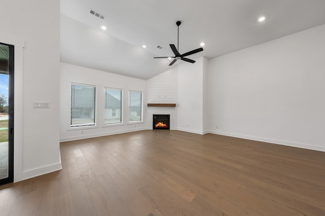 unfurnished living room with ceiling fan, high vaulted ceiling, a fireplace, and dark hardwood / wood-style floors