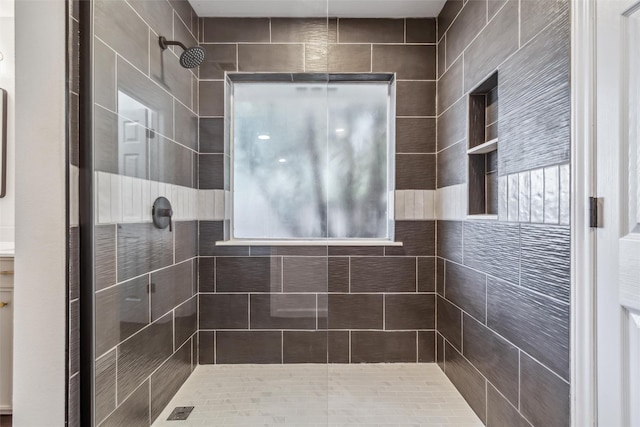 bathroom with a tile shower