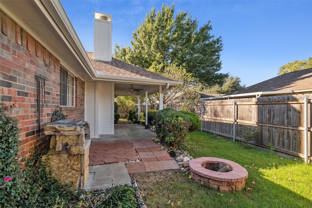 view of yard with a patio, ceiling fan, and an outdoor fire pit