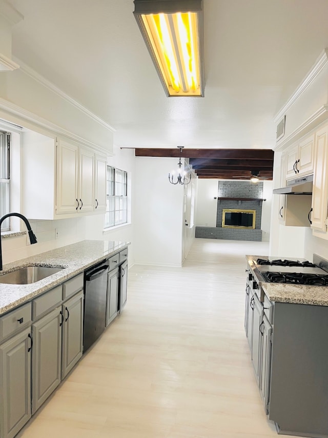 kitchen featuring appliances with stainless steel finishes, sink, light hardwood / wood-style floors, gray cabinets, and light stone counters