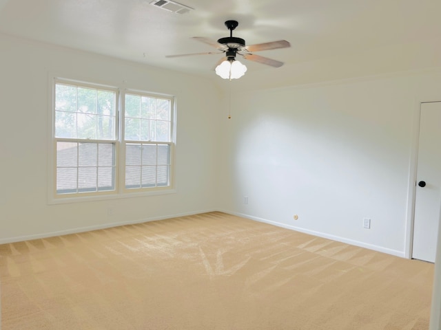 spare room featuring ceiling fan and light colored carpet