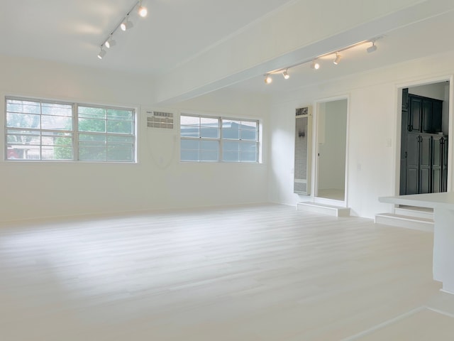 unfurnished room with a wealth of natural light and rail lighting