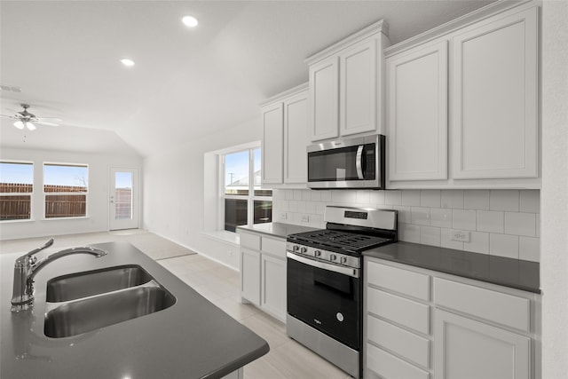 kitchen featuring plenty of natural light, sink, white cabinetry, and stainless steel appliances