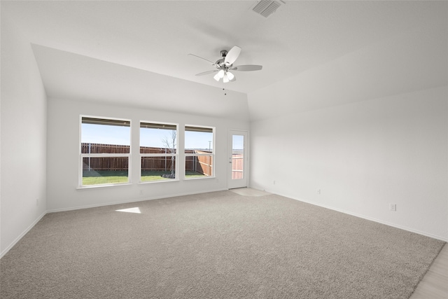 carpeted spare room with lofted ceiling and ceiling fan