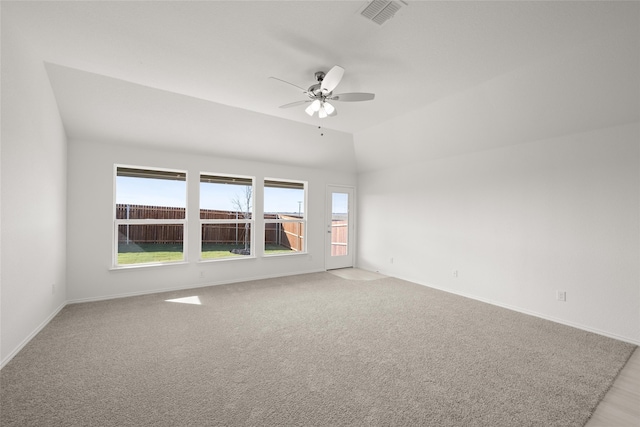 carpeted spare room with ceiling fan and vaulted ceiling