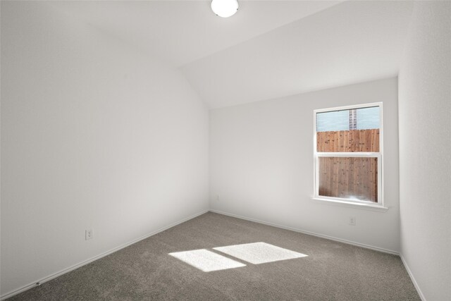 unfurnished living room featuring light carpet, ceiling fan, and vaulted ceiling