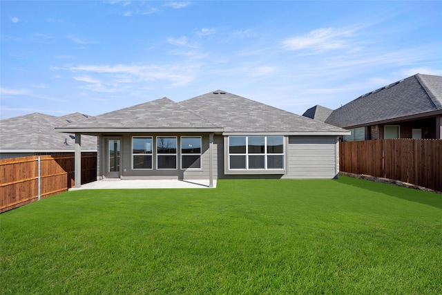 rear view of house with a patio area and a yard