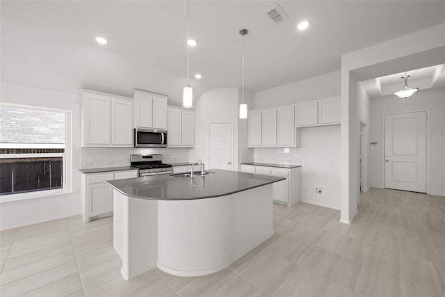 kitchen featuring a center island with sink, white cabinets, sink, and appliances with stainless steel finishes