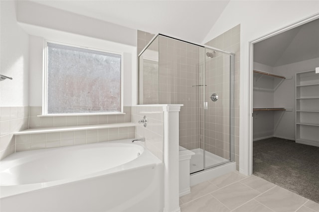 bathroom featuring tile patterned floors, lofted ceiling, and shower with separate bathtub