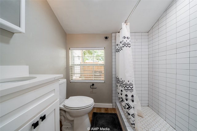 bathroom featuring vanity, toilet, curtained shower, and hardwood / wood-style floors