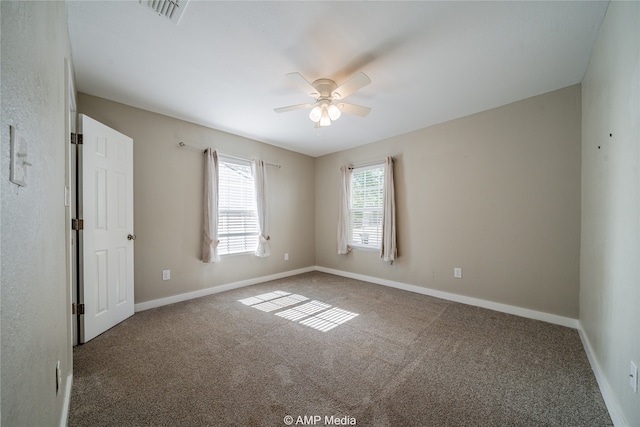 spare room with carpet and ceiling fan