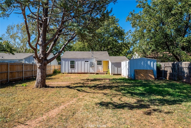 rear view of house with a yard