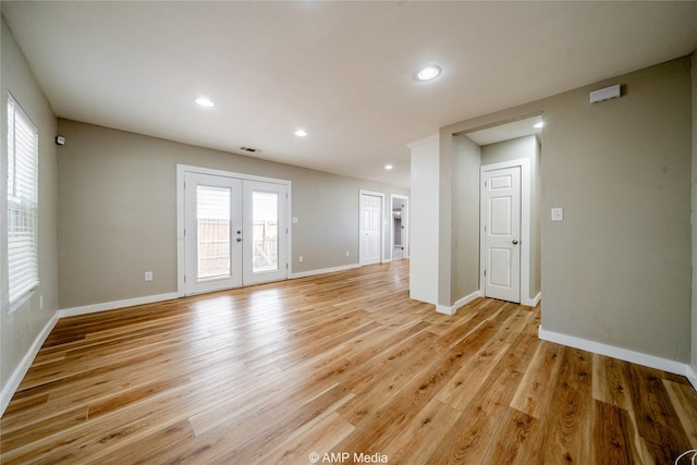 unfurnished room with light wood-type flooring, recessed lighting, baseboards, and french doors