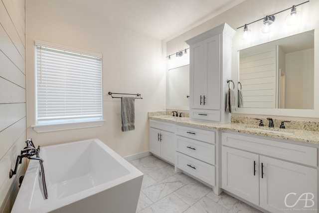 bathroom with a tub and vanity