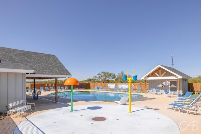 view of swimming pool with an outdoor structure and a patio