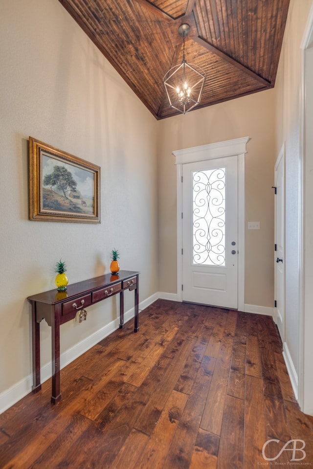 foyer entrance with a chandelier, dark wood-type flooring, wooden ceiling, and vaulted ceiling