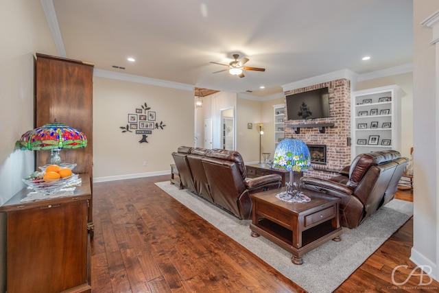 living room with ceiling fan, a fireplace, dark wood-type flooring, and ornamental molding