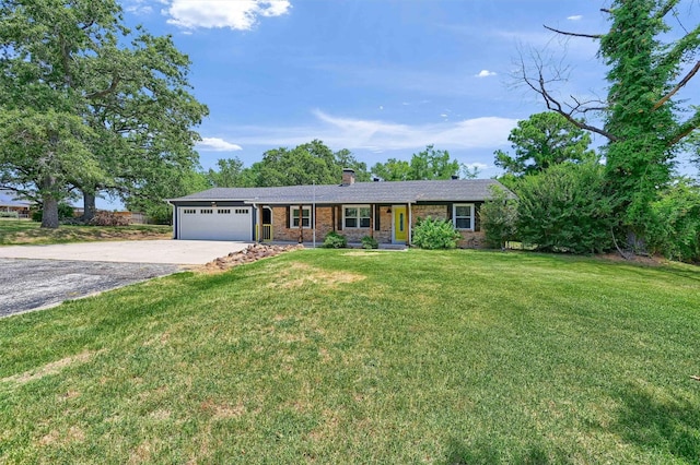 ranch-style home with a garage, concrete driveway, a chimney, a front lawn, and brick siding