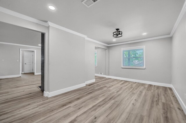 unfurnished room featuring electric panel, light hardwood / wood-style flooring, and ornamental molding