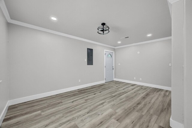 unfurnished living room featuring ceiling fan, ornamental molding, and light wood-type flooring