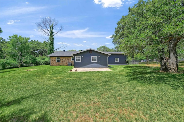 back of house featuring a patio area and a yard