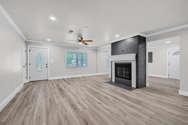 unfurnished living room featuring ceiling fan, crown molding, light hardwood / wood-style floors, and a fireplace