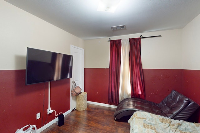 bedroom with dark wood-type flooring