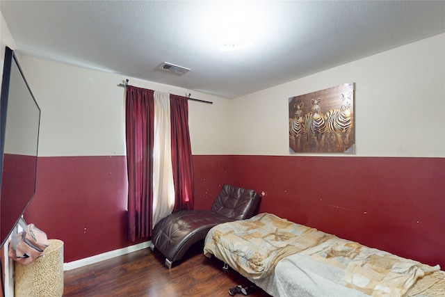 bedroom with dark hardwood / wood-style floors