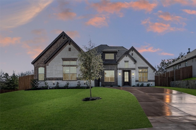 french country inspired facade with a lawn