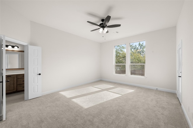 carpeted spare room featuring ceiling fan