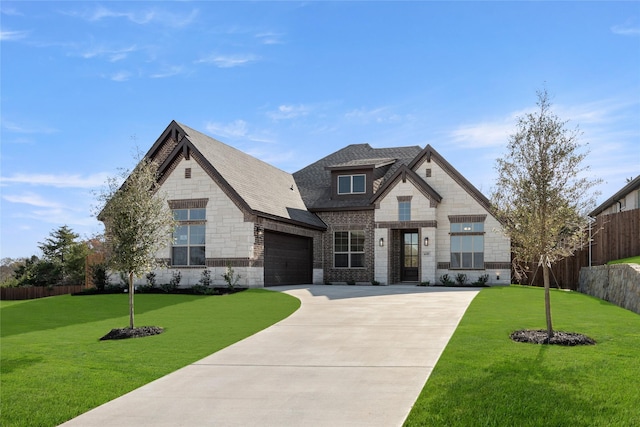 view of front of property featuring a garage and a front lawn