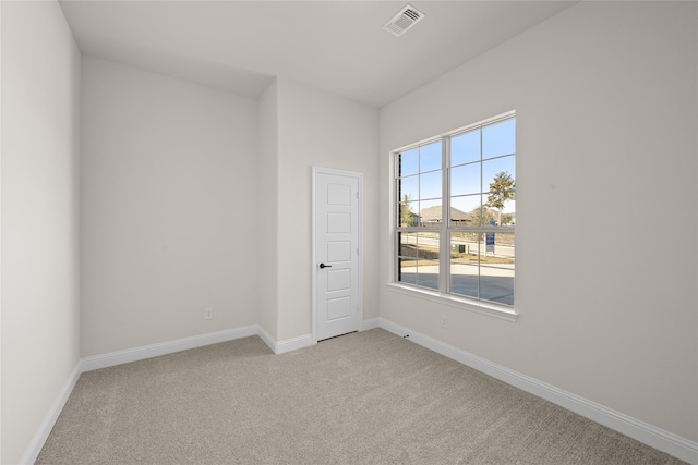 empty room featuring light carpet