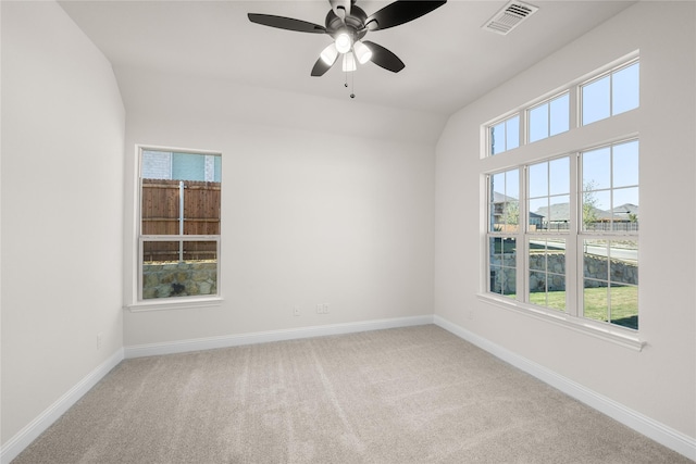 spare room with lofted ceiling, ceiling fan, and carpet