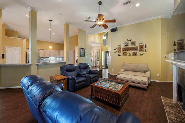 living room with ornamental molding, dark hardwood / wood-style floors, and ceiling fan