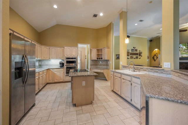 kitchen with kitchen peninsula, decorative backsplash, a kitchen island, sink, and stainless steel appliances