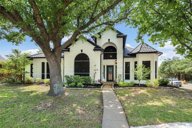 mediterranean / spanish-style home featuring a front yard