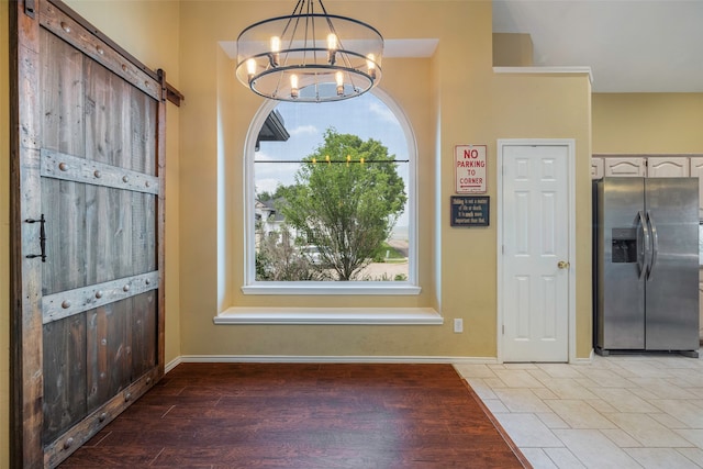 entryway with a notable chandelier and light hardwood / wood-style flooring