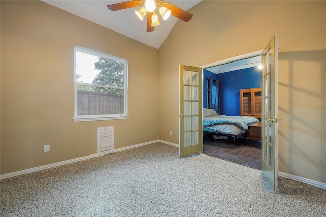 unfurnished bedroom with french doors, lofted ceiling, carpet, and ceiling fan