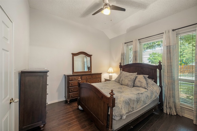 bedroom featuring ceiling fan, a textured ceiling, lofted ceiling, and dark hardwood / wood-style flooring