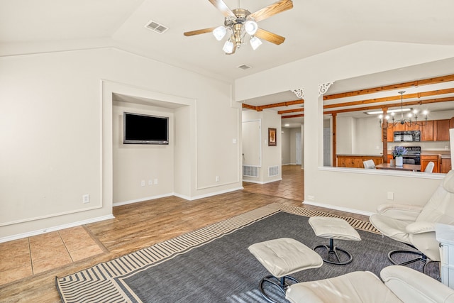 living room featuring ceiling fan, light hardwood / wood-style flooring, and vaulted ceiling