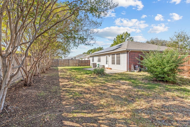 view of yard with central AC and a patio area