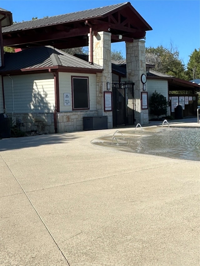 view of front facade with a community pool