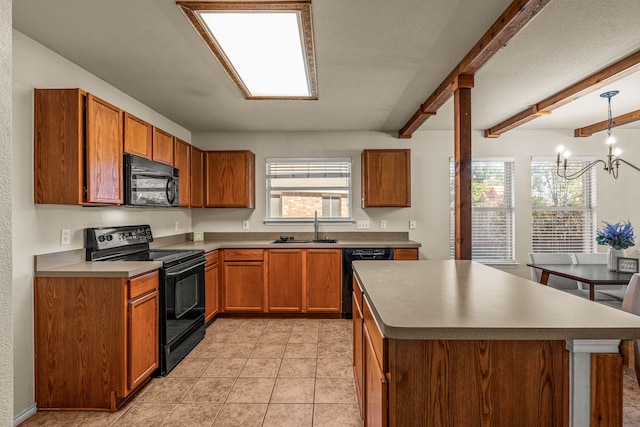 kitchen with beamed ceiling, sink, black appliances, hanging light fixtures, and a chandelier