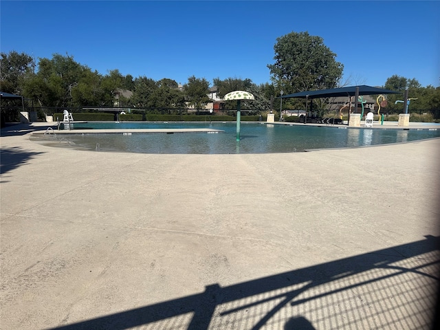 view of swimming pool with a patio and pool water feature