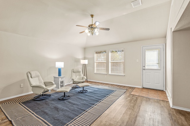 living area featuring hardwood / wood-style flooring, ceiling fan, and lofted ceiling