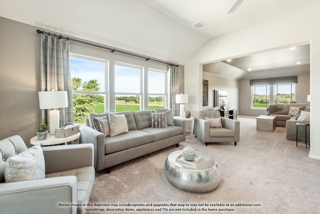 living room with light carpet, ceiling fan, and vaulted ceiling