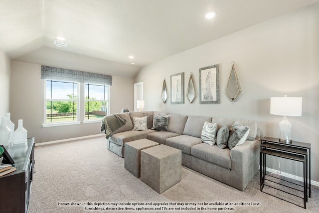 living room with vaulted ceiling and light colored carpet