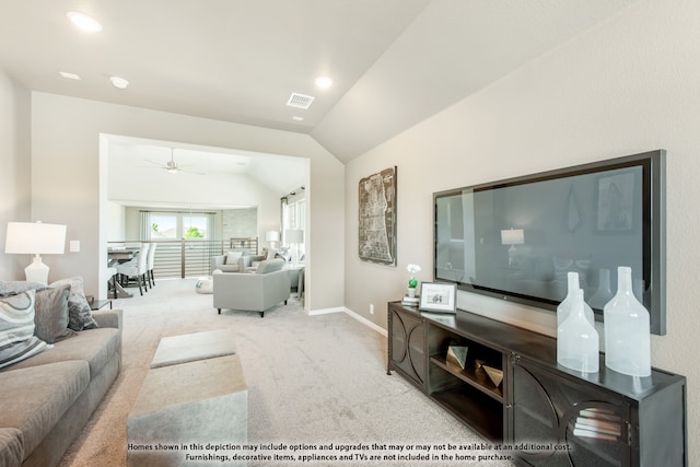 carpeted living room featuring ceiling fan and lofted ceiling