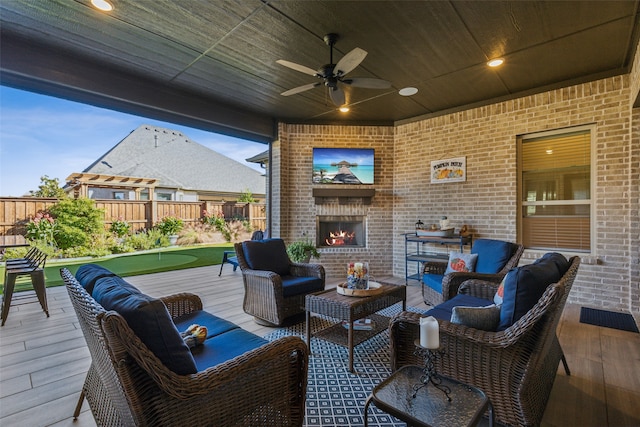 view of patio featuring an outdoor living space, ceiling fan, and a deck